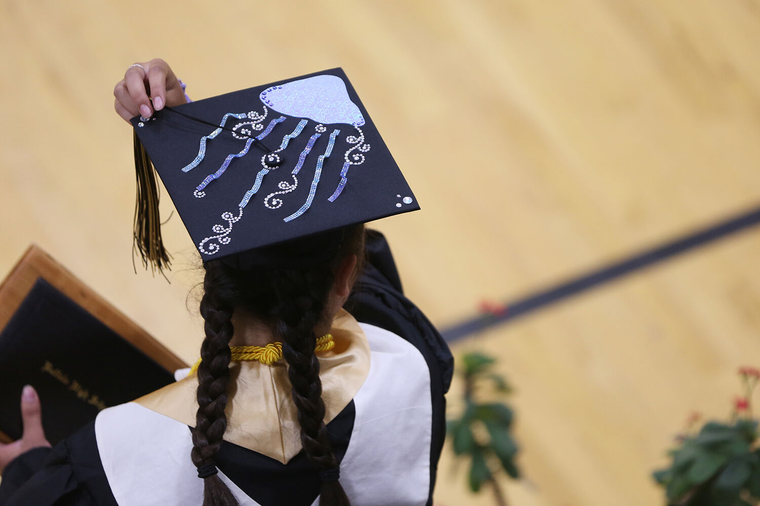 Luci Riddle turns her tassel as she steps off the stage